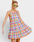 Woman wearing a colorful plaid dress on a white background