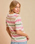 Woman wearing a striped sweater against a beige background
