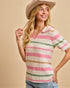 Woman wearing a striped sweater and hat on a beige background