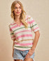 Woman wearing a striped shirt and denim shorts against a beige background