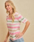 Woman wearing a striped sweater with a beige background