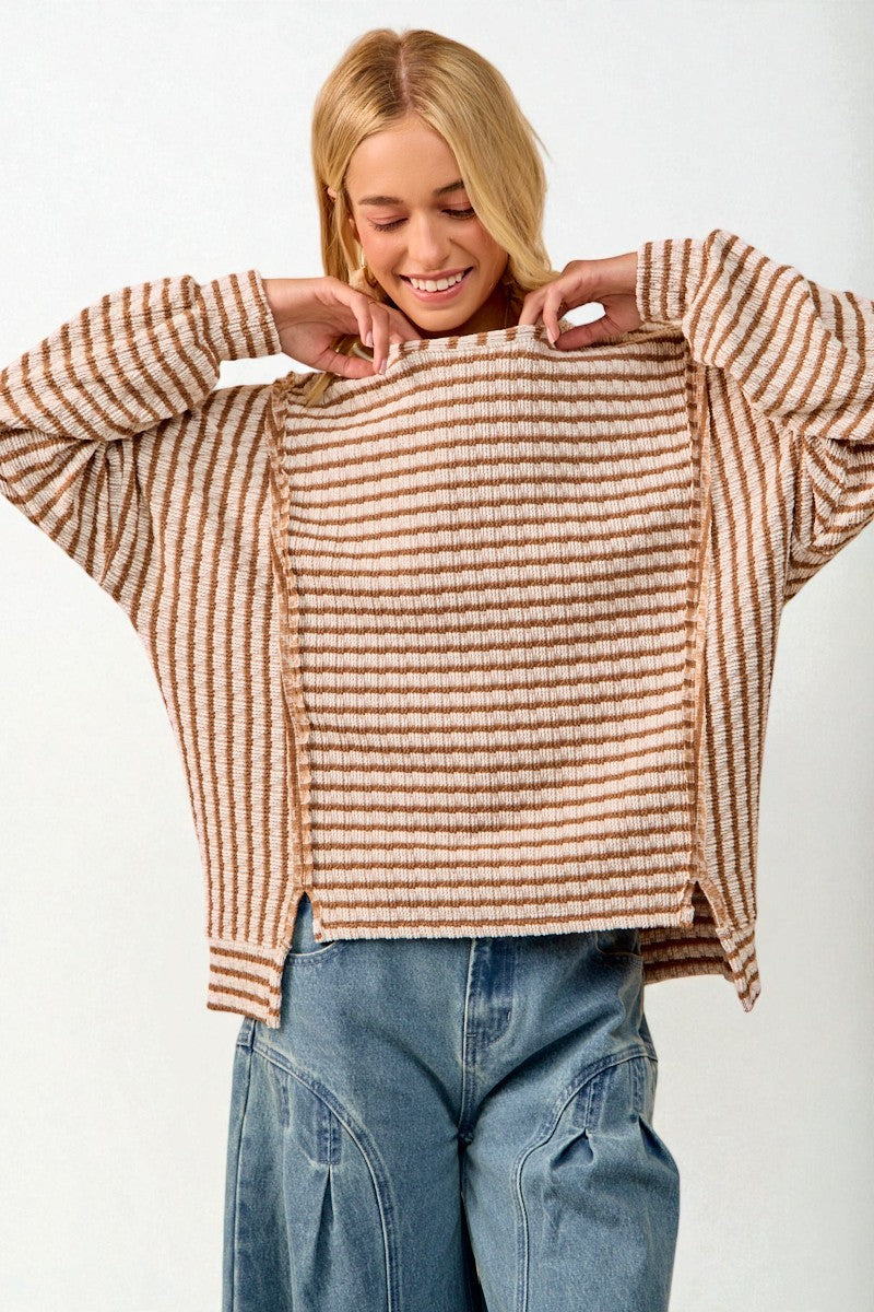 Woman wearing a striped sweater and jeans on a white background