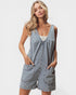 Woman wearing a denim romper on a white background