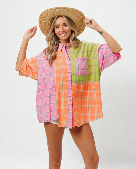Person wearing a colorful plaid shirt and straw hat on a white background