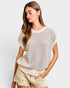 Woman wearing a striped sweater and shorts on a plain background