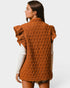 Woman wearing a brown quilted vest on a white background