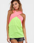 Woman wearing a neon green and pink top on a white background