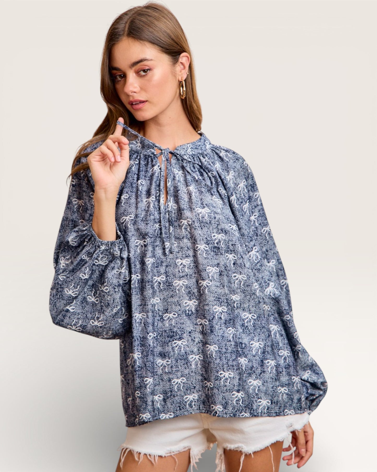 Woman wearing a blue floral blouse with white background