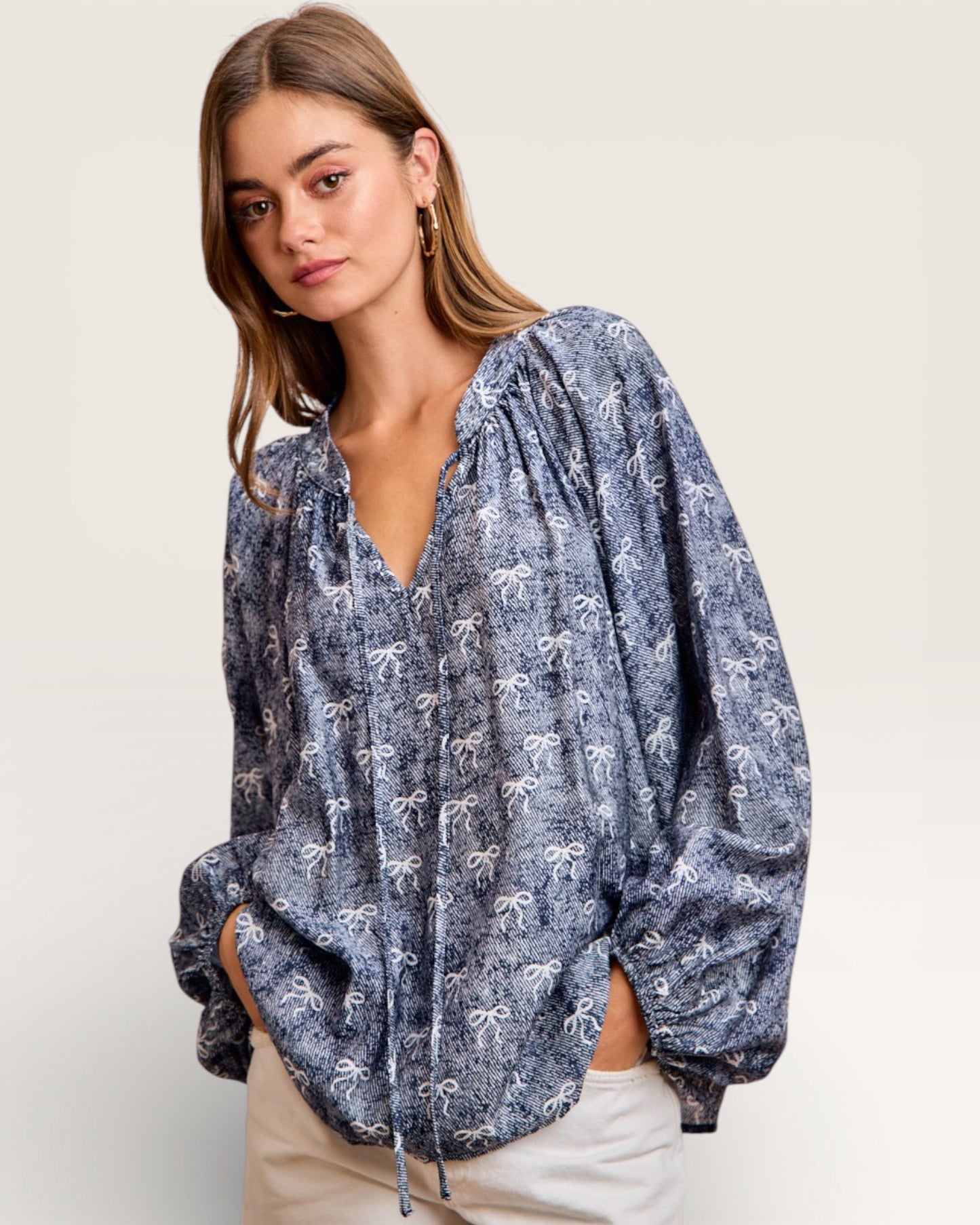 Woman wearing a blue patterned blouse on a white background