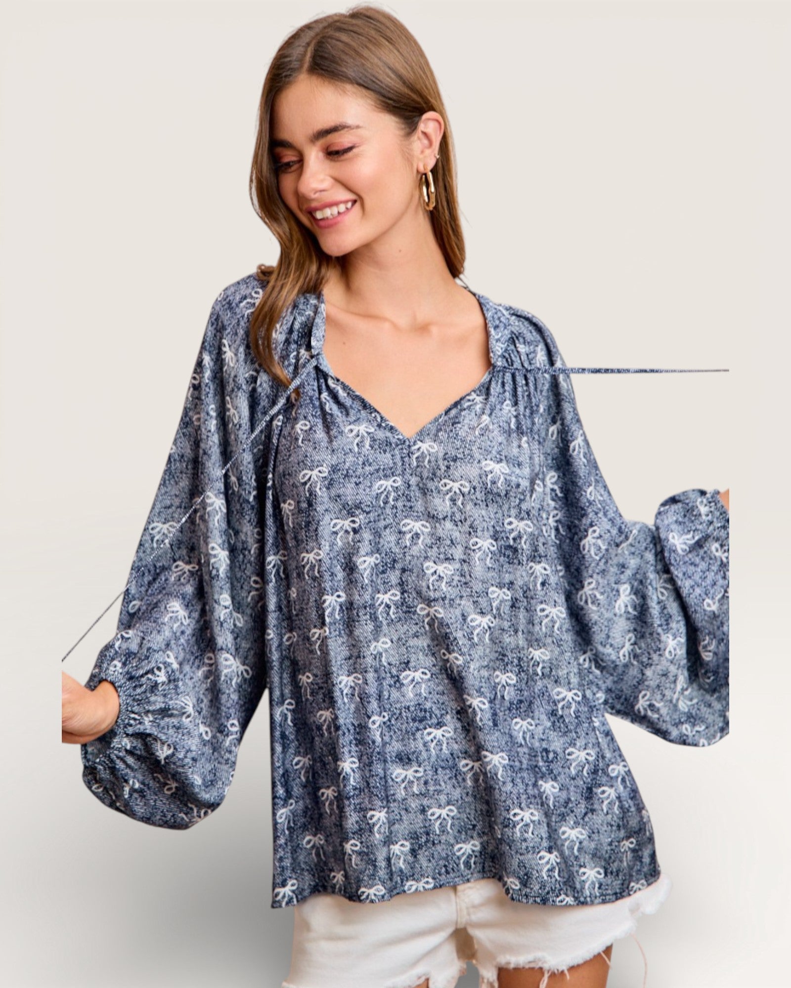 Woman wearing a blue floral blouse with a plain background