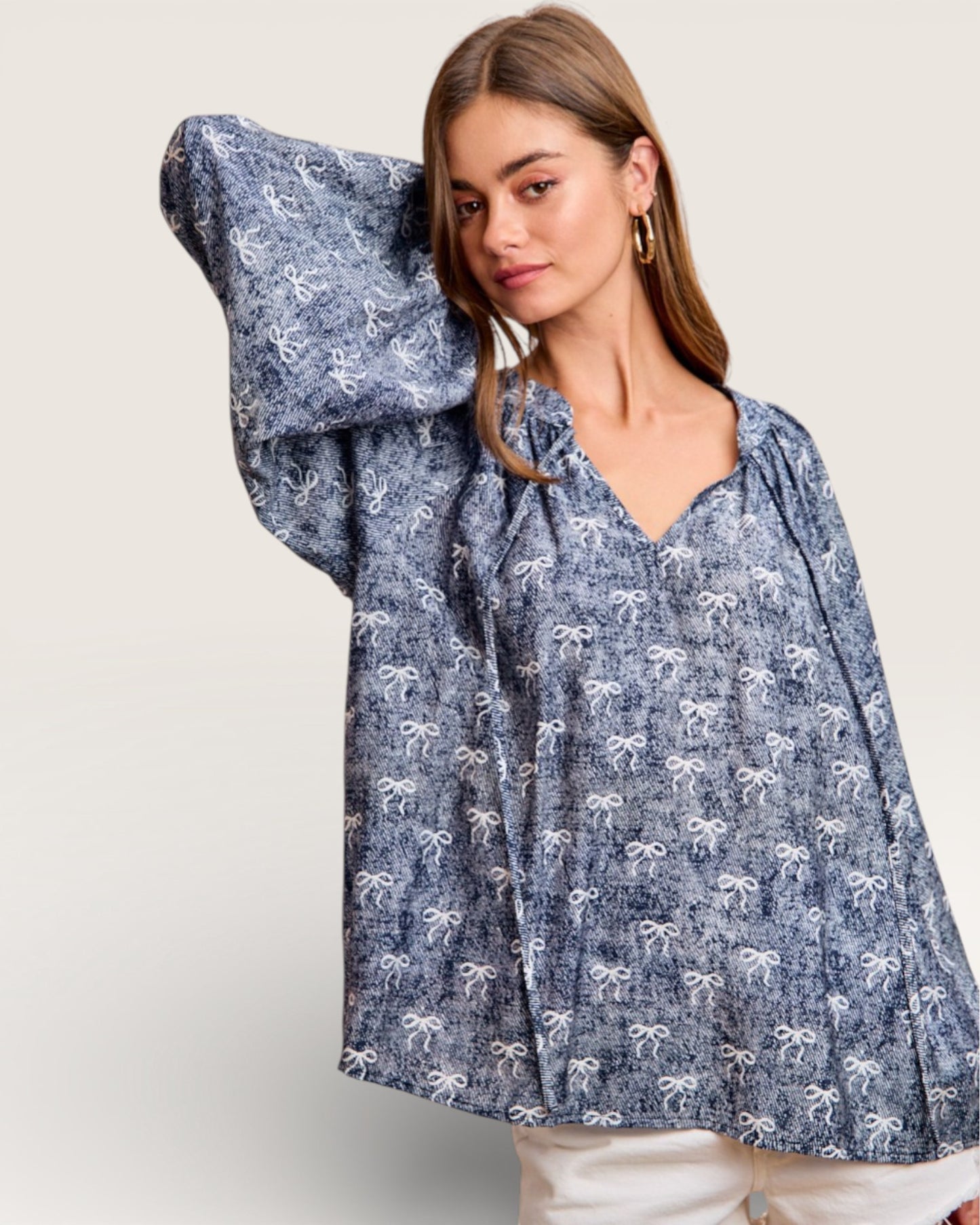 Woman wearing a blue floral blouse with a plain background