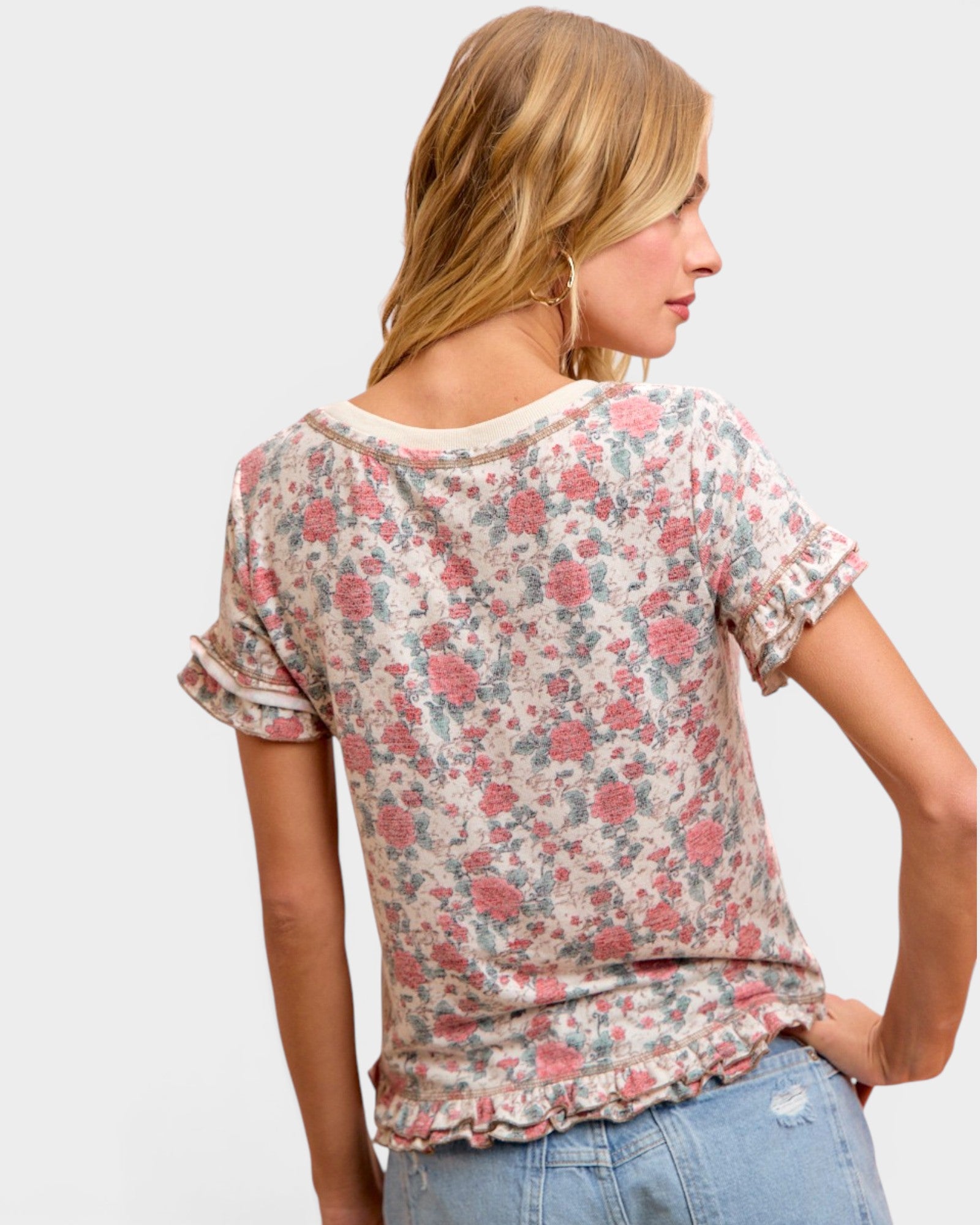 Woman wearing a floral blouse with a plain background