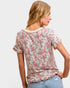 Woman wearing a floral blouse with a plain background