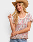 Woman wearing a floral blouse and cowboy hat on a white background