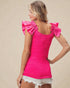 Woman wearing a bright pink top with ruffled shoulders on a beige background