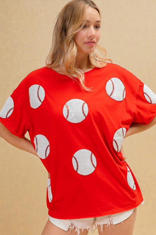 Woman wearing a red shirt with white polka dot patterns on a beige background