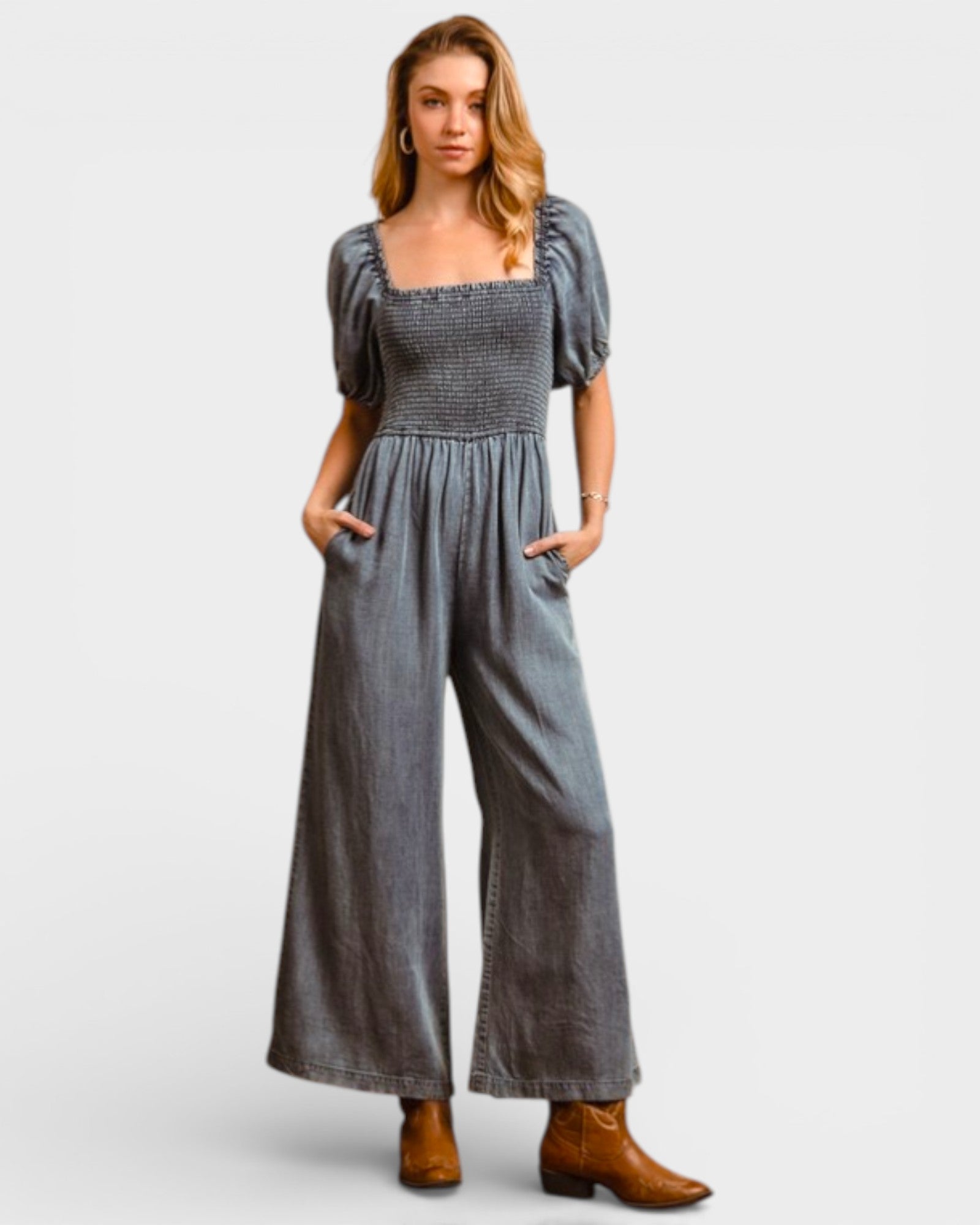 Woman wearing a gray jumpsuit on a white background
