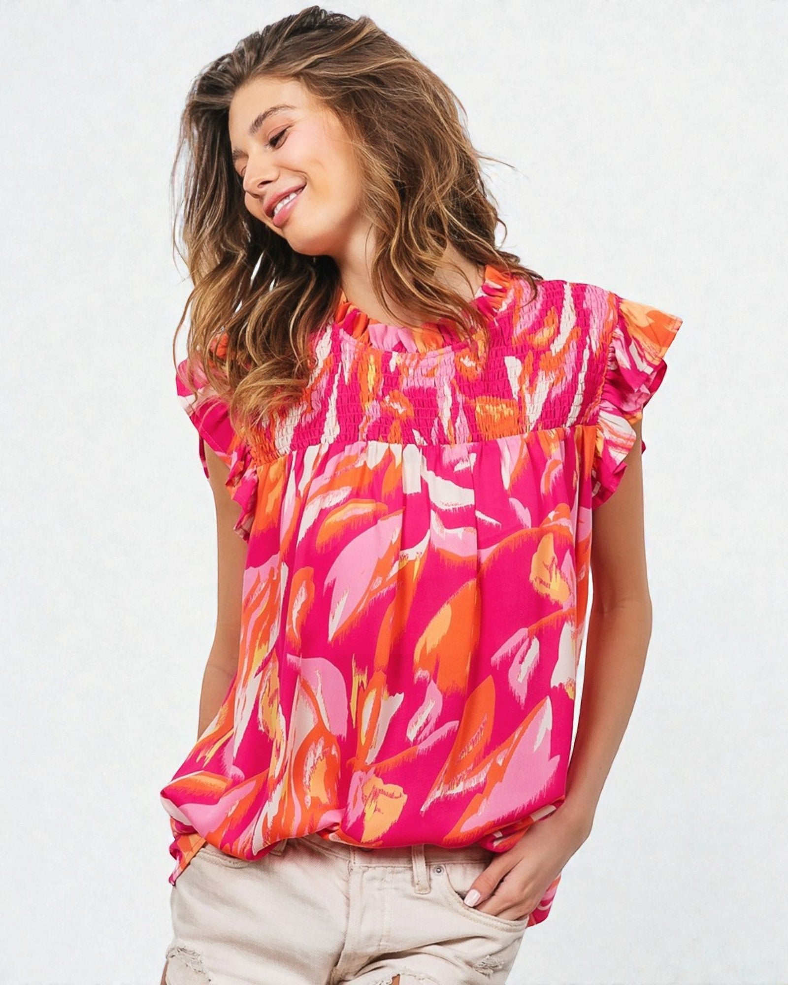 Young girl wearing a colorful floral blouse on a white background