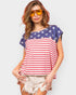 Woman wearing a sleeveless top with American flag design on a plain background