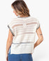 A woman shown from the back wearing a cream-colored open-knit short-sleeve top with black striped sleeve cuffs, paired with blue jeans, against a plain white background.