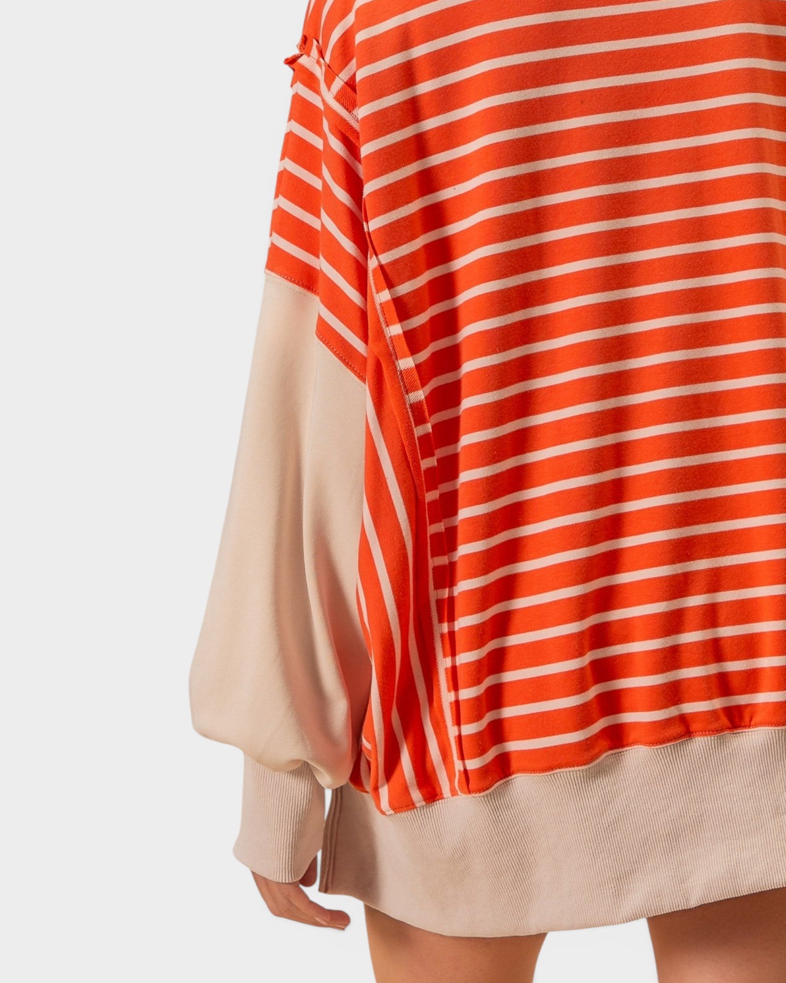 Orange and white striped dress with beige accents on a white background