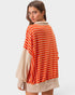 Woman wearing a striped sweater with a plain background
