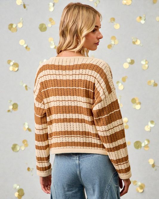 Woman wearing a brown and beige striped sweater with gold confetti on a light gray background