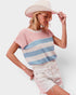 Woman wearing a striped sweater and wide-brimmed hat on a white background