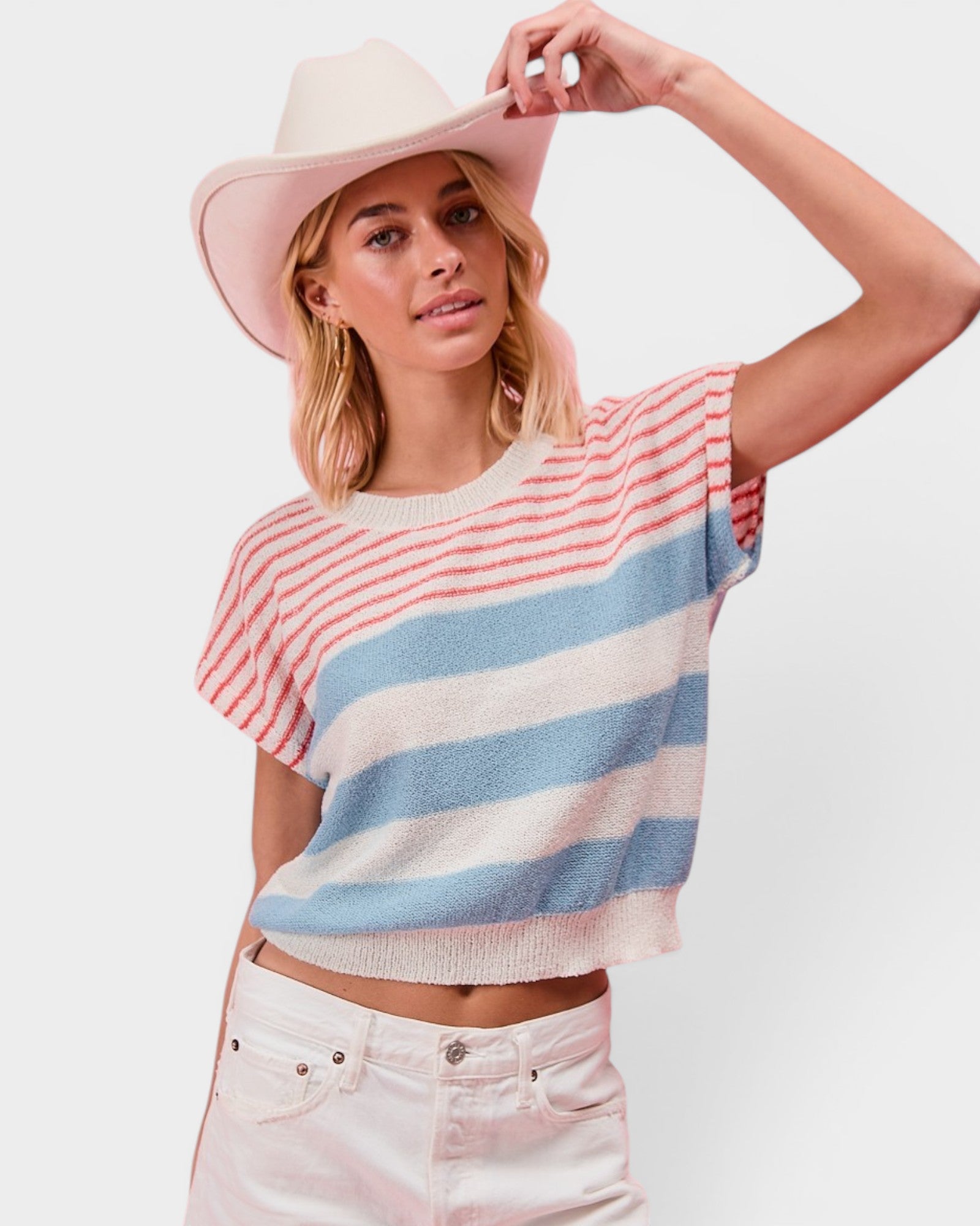 Woman wearing a striped sweater and wide-brimmed hat on a white background