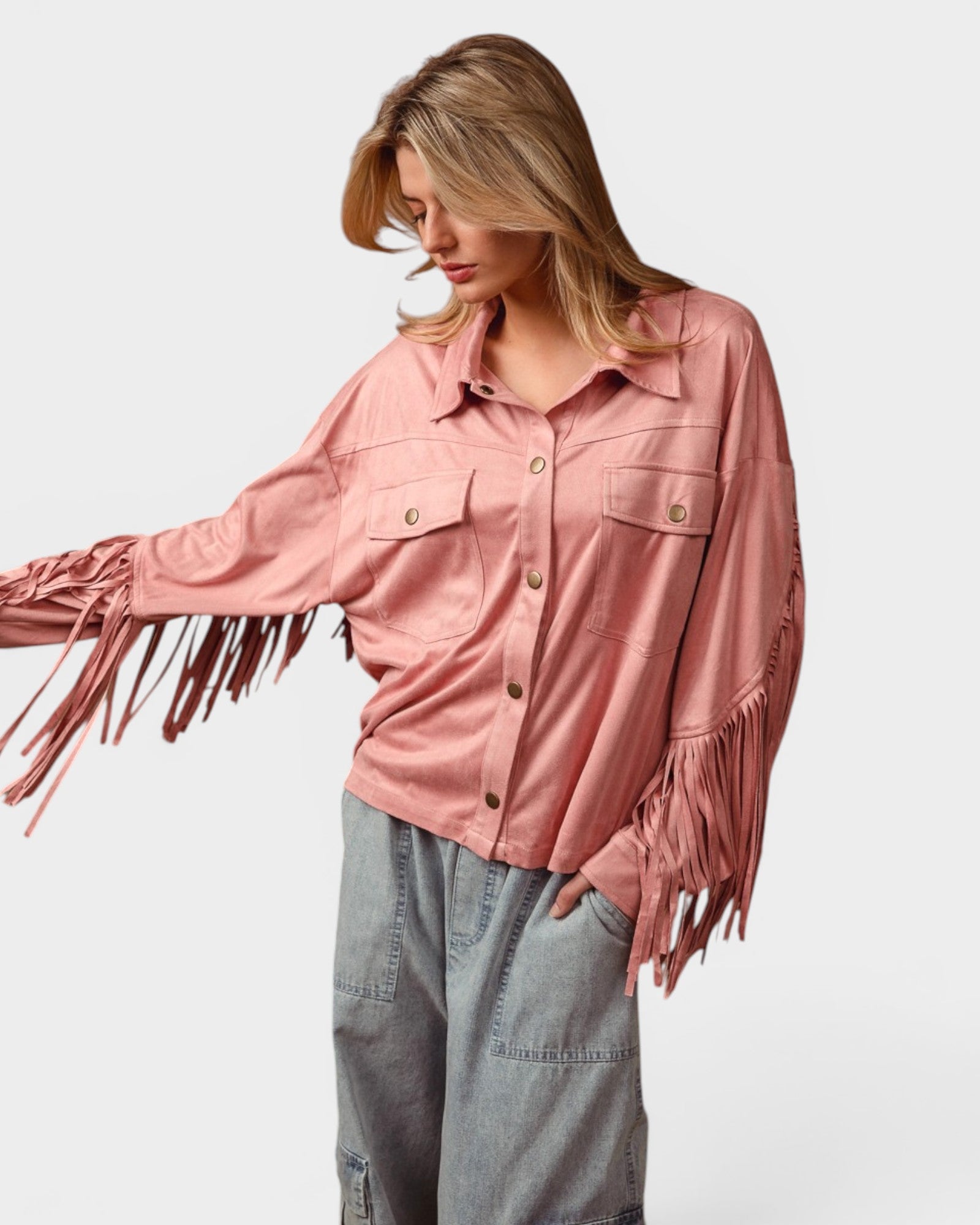 Woman wearing a pink fringed jacket on a white background