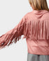Pink fringed jacket worn by a person on a light gray background