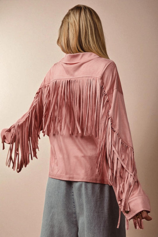 Person wearing a pink fringed jacket on a beige background