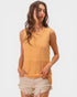 Woman wearing a mustard yellow sleeveless top with a white background