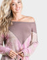 Woman wearing a pink and gray off-shoulder top on a white background