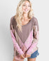 Woman wearing a patterned sweater with pink and brown colors on a white background