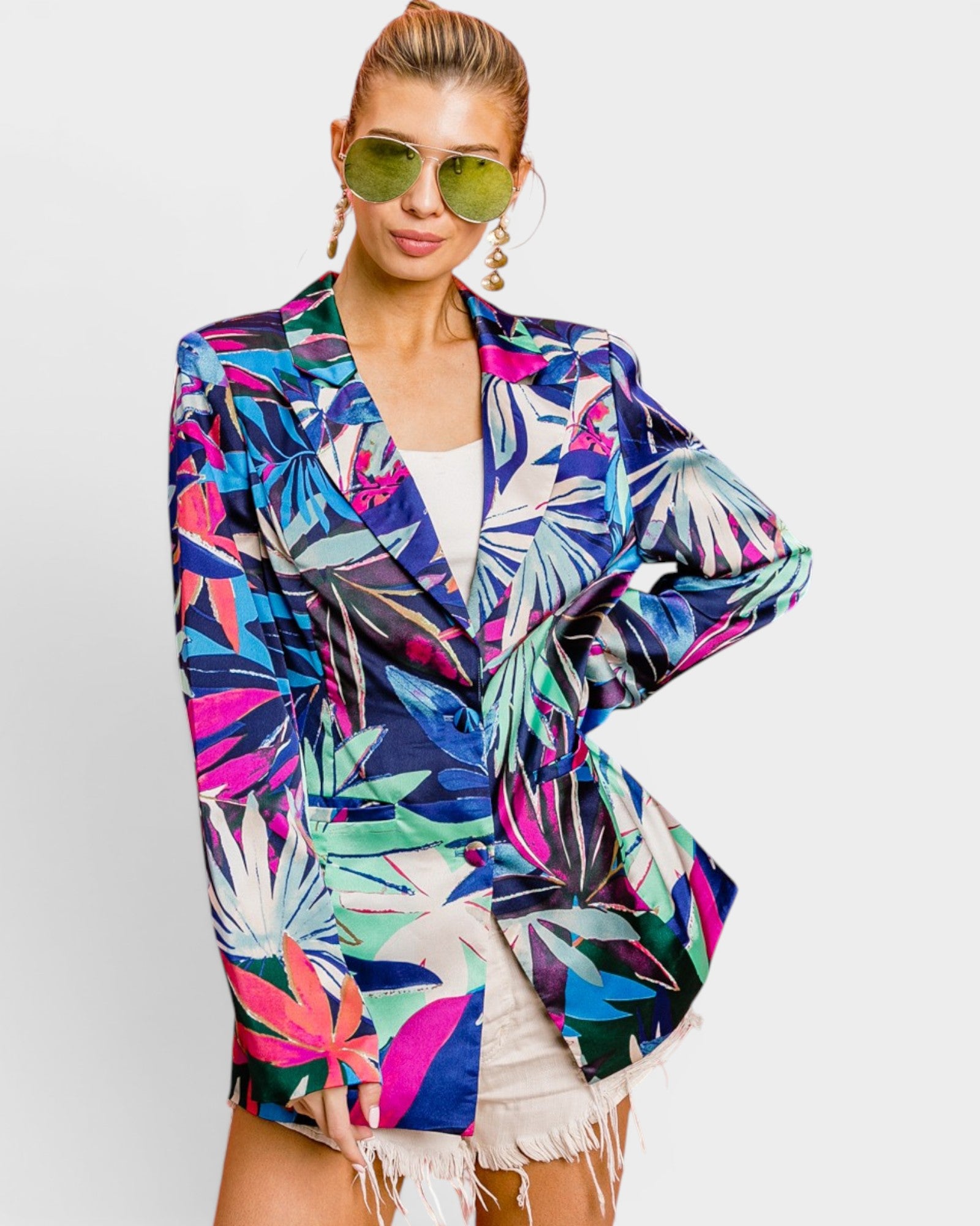 Woman wearing a colorful tropical print jacket on a white background