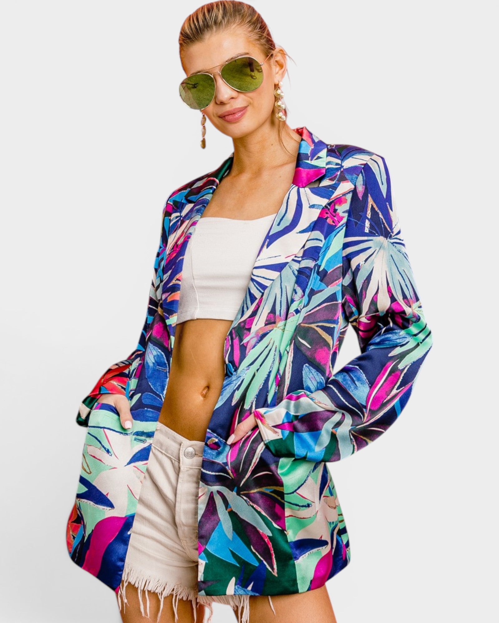 Woman wearing a colorful floral jacket on a white background