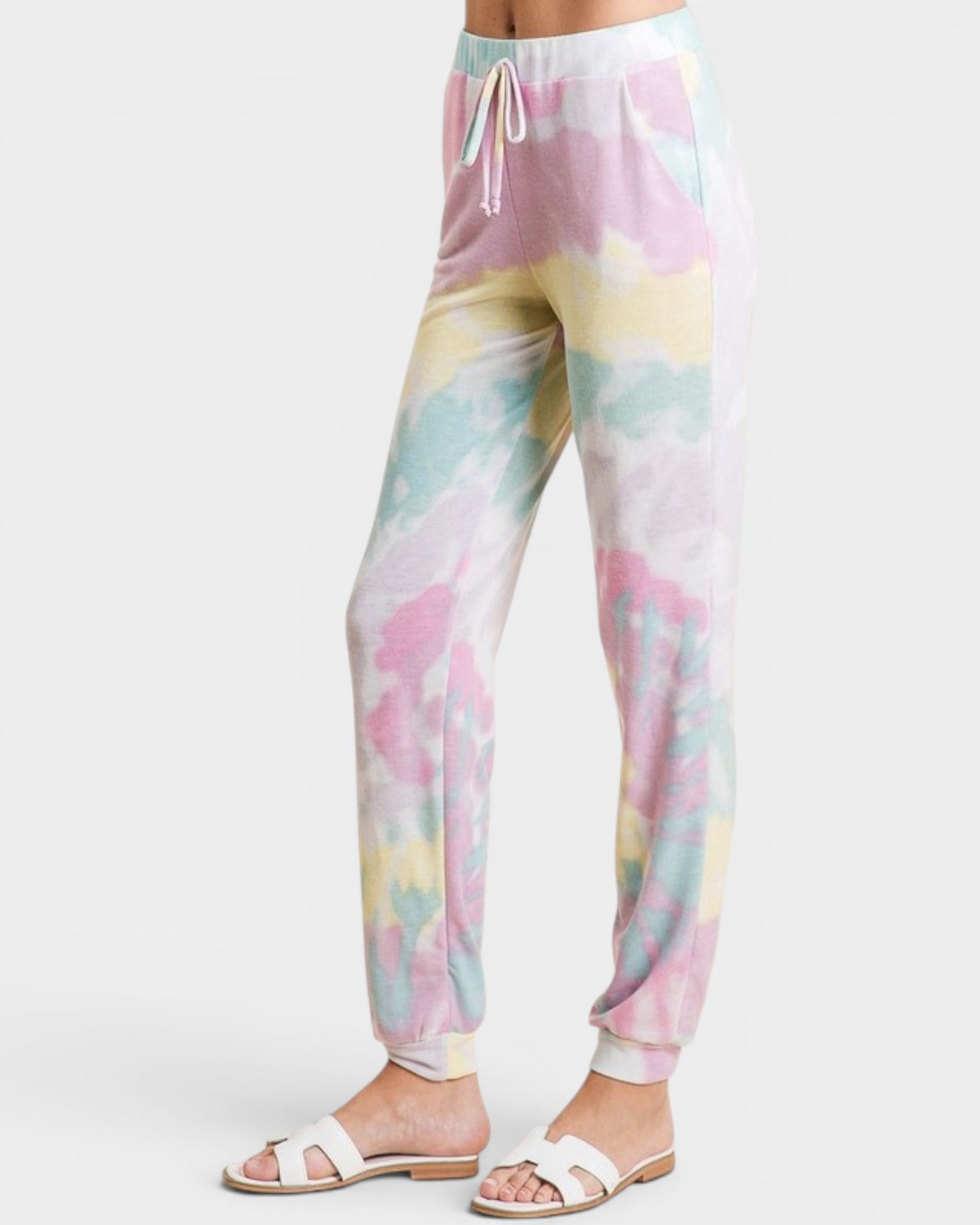 Pastel tie-dye jogger pants on a white background
