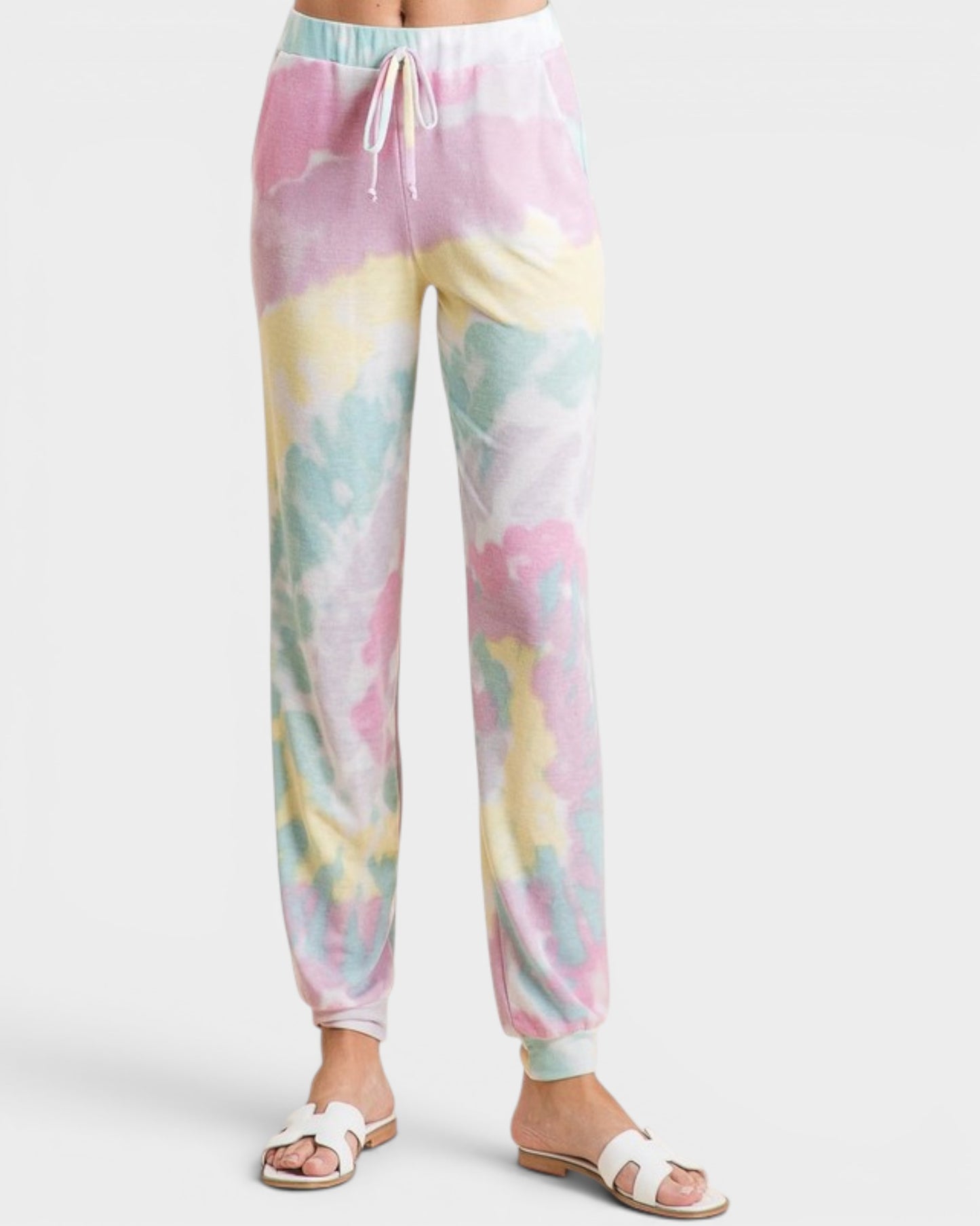 Pastel tie-dye pants worn by a person on a white background