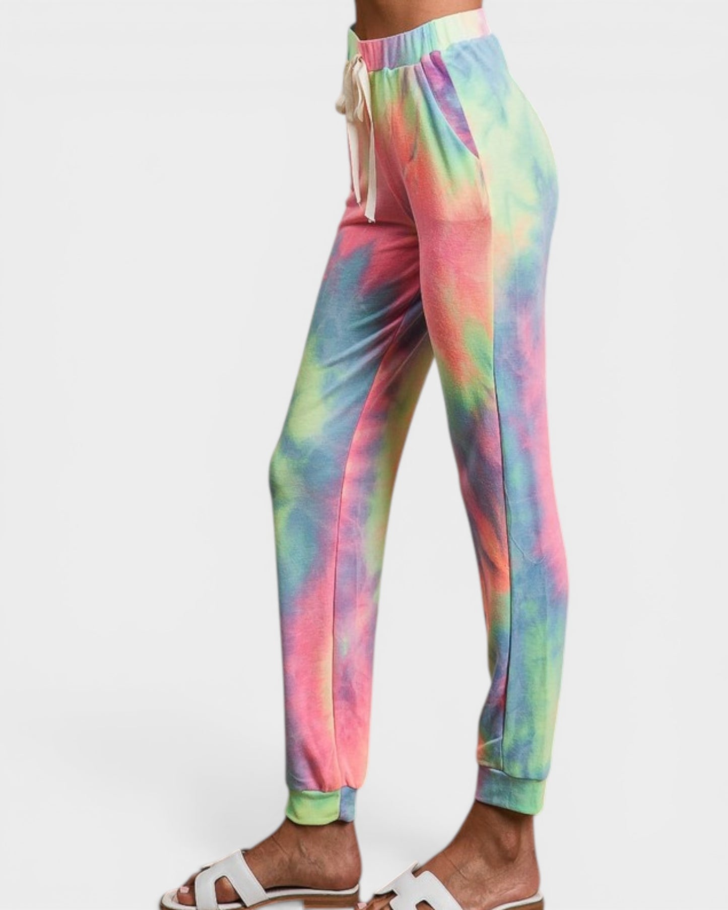 Tie-dye pants worn by a person on a white background