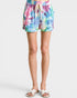 Multicolored tie-dye shorts worn by a person on a white background