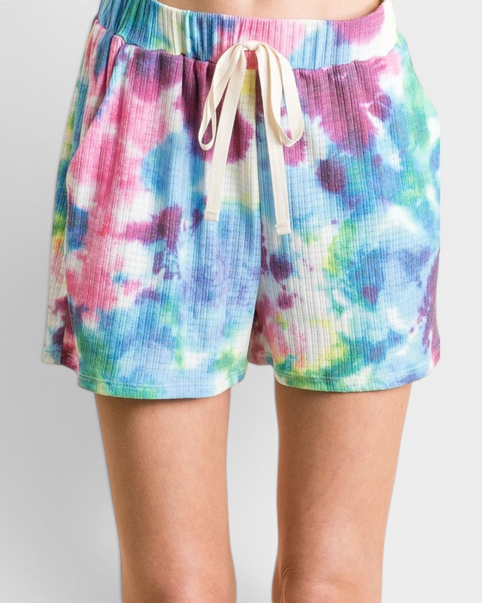 Colorful tie-dye shorts with a drawstring on a plain background