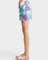 Colorful tie-dye shorts worn by a person on a white background
