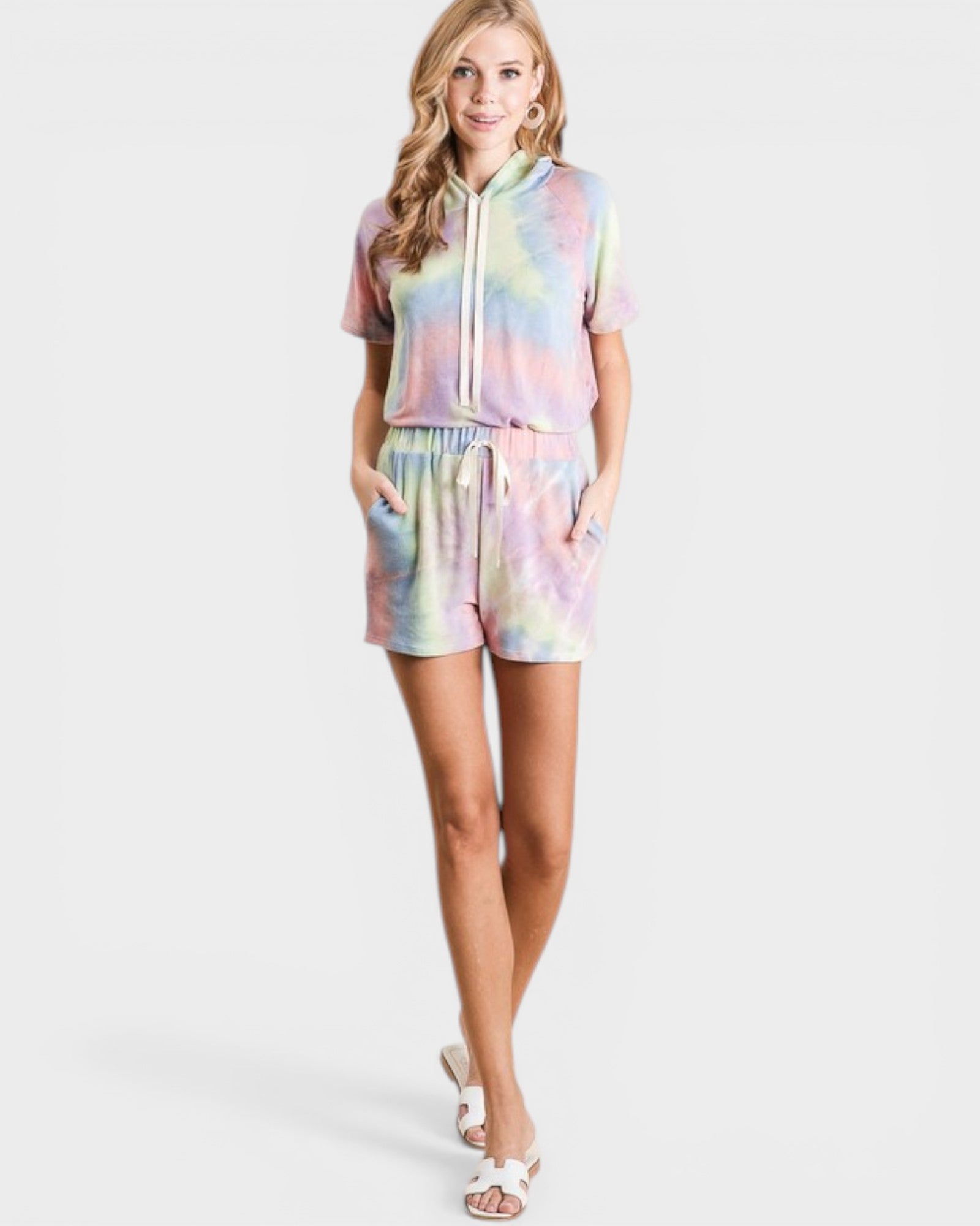 Woman wearing a tie-dye outfit on a white background