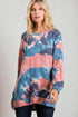 Woman wearing a tie-dye sweater with a neutral background