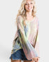 Woman wearing a tie-dye shirt with a white background