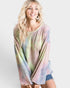 Woman wearing a tie-dye shirt with pastel colors on a white background