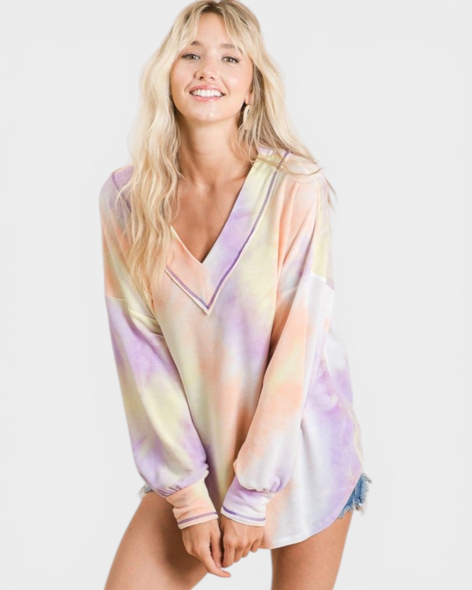 Woman wearing a pastel tie-dye dress on a white background