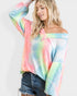 Woman wearing a colorful tie-dye off-shoulder top on a white background