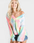 Woman wearing a colorful tie-dye off-shoulder top on a white background